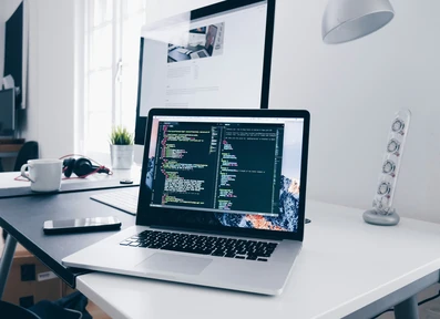 Open laptop with website code being displayed.